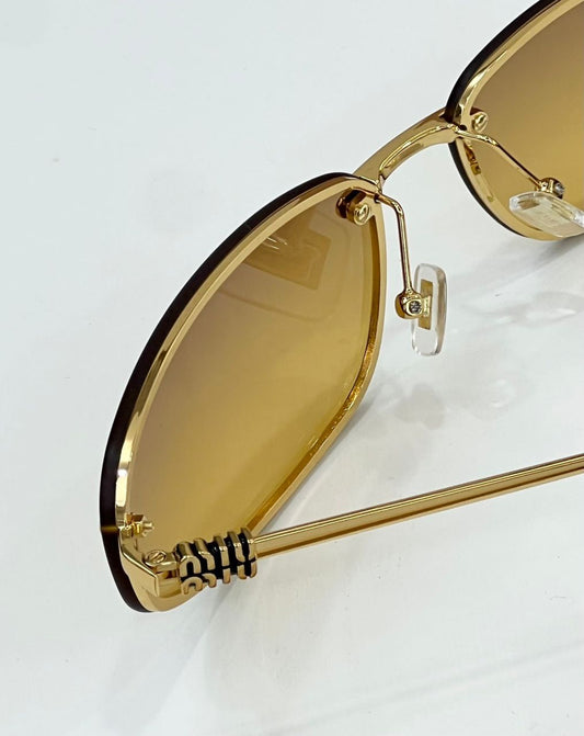 Óculos Miu Miu Gold